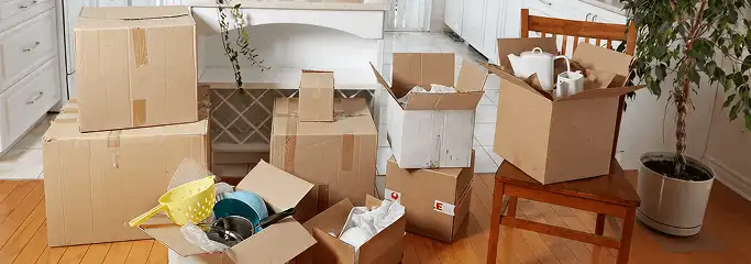 Packed moving boxes and household items in a kitchen before move-out or move-in cleaning, Sarasota, FL.